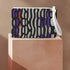 Rectangular wristlet clutch bag with psychedelic black, purple, red, and green pattern. White wrist strap and gold zipper visible